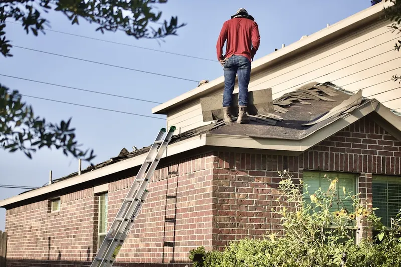 Professional roofer working on a residential roof in Four Square Mile